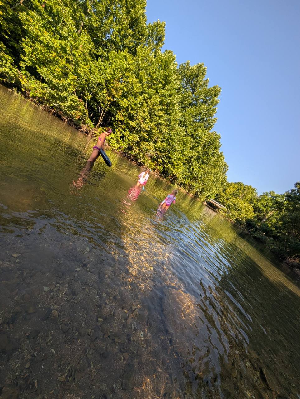 Clear shallow water and families wading at Five Mile Creek